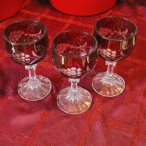 3 red crystal wine glasses.